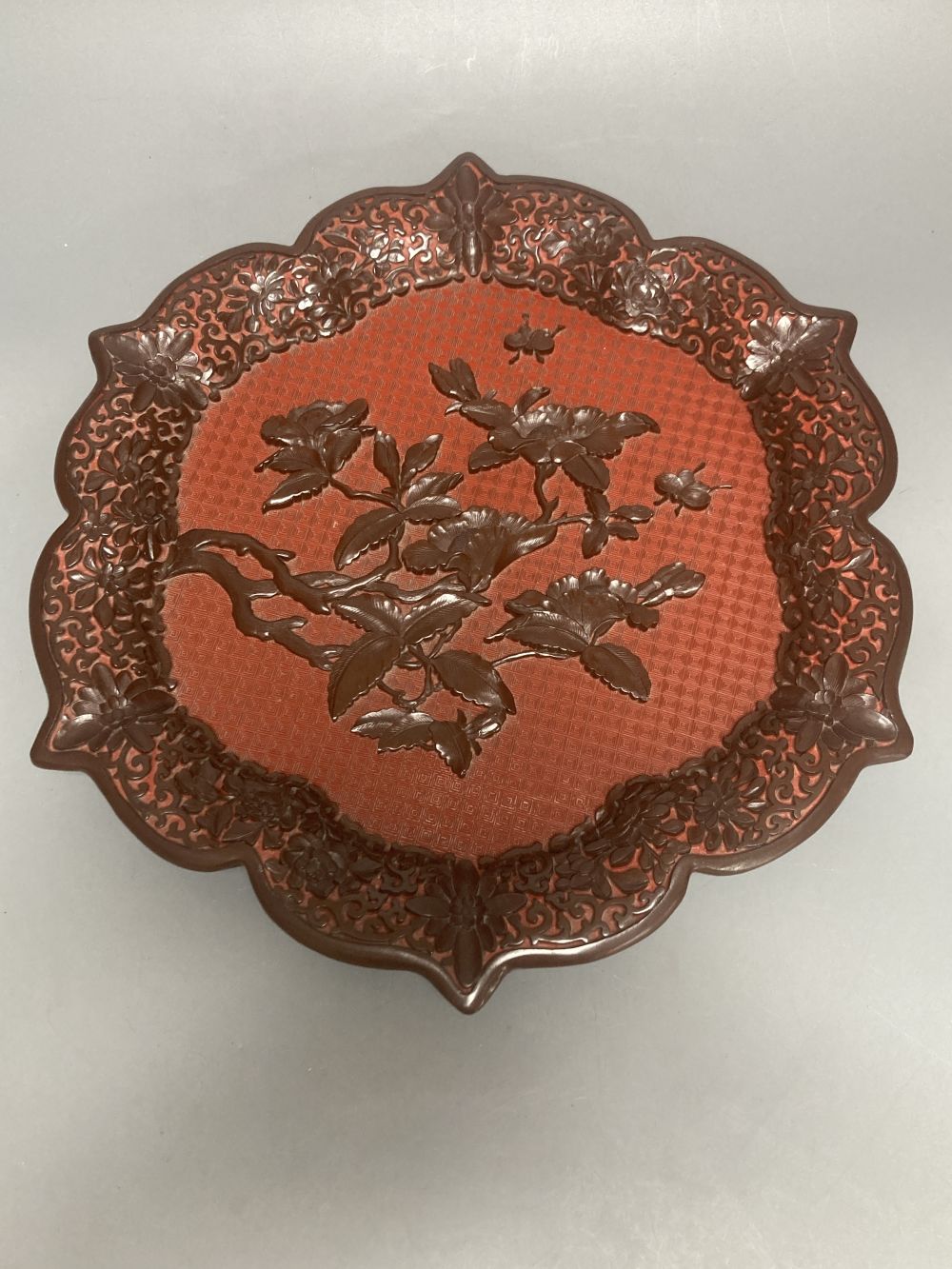 A Chinese carved cinnabar lacquer dish, early 20th century, 33.5cm